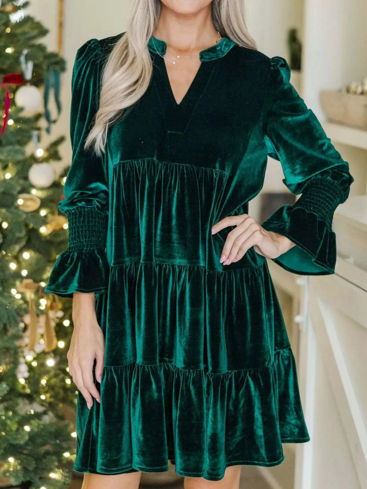 Velvet Tiered Notched Mini Dress in emerald green with long puff sleeves.
