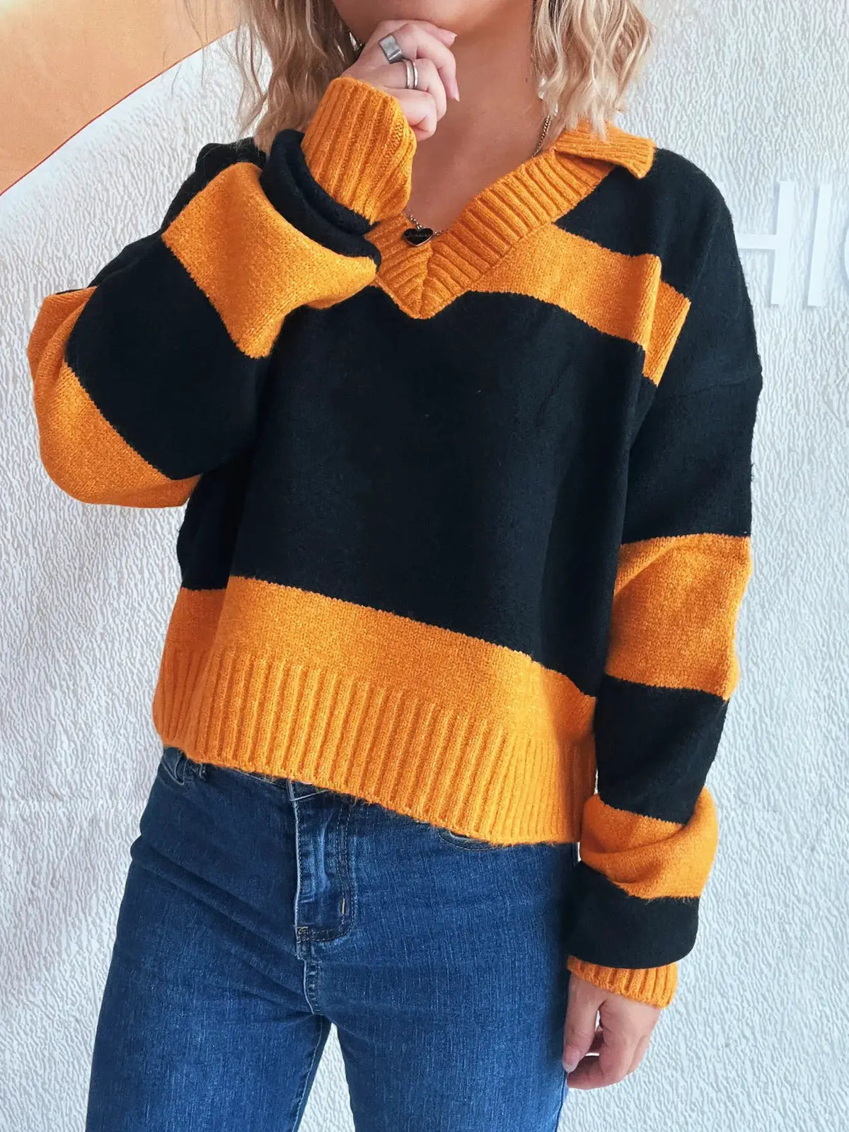Color block long sleeve sweater in black and orange with ribbed cuffs and hem, soft stretch polyester blend from Trendsi