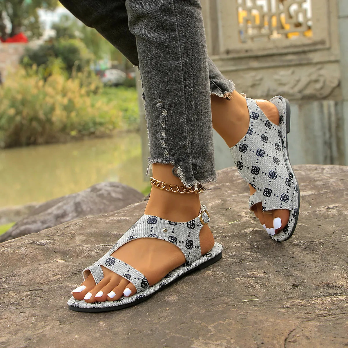 Toe Loop Flats Sandals in light gray fabric with dark printed pattern and ankle strap buckle