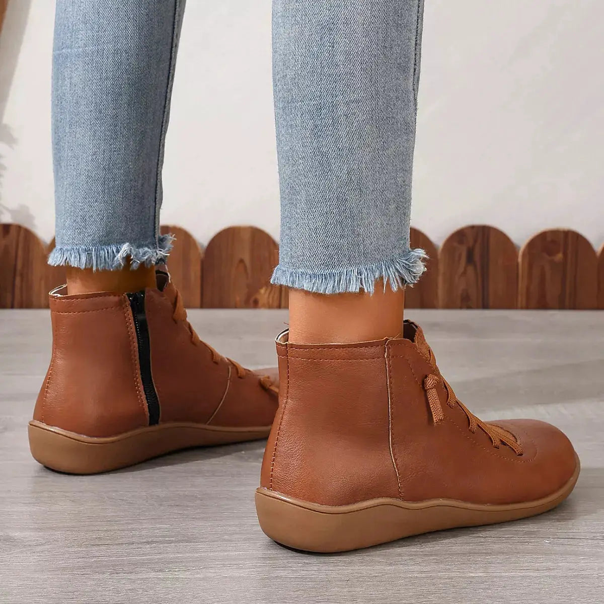 Pair of tan lace-up faux-leather ankle boots with side zipper and chunky sole