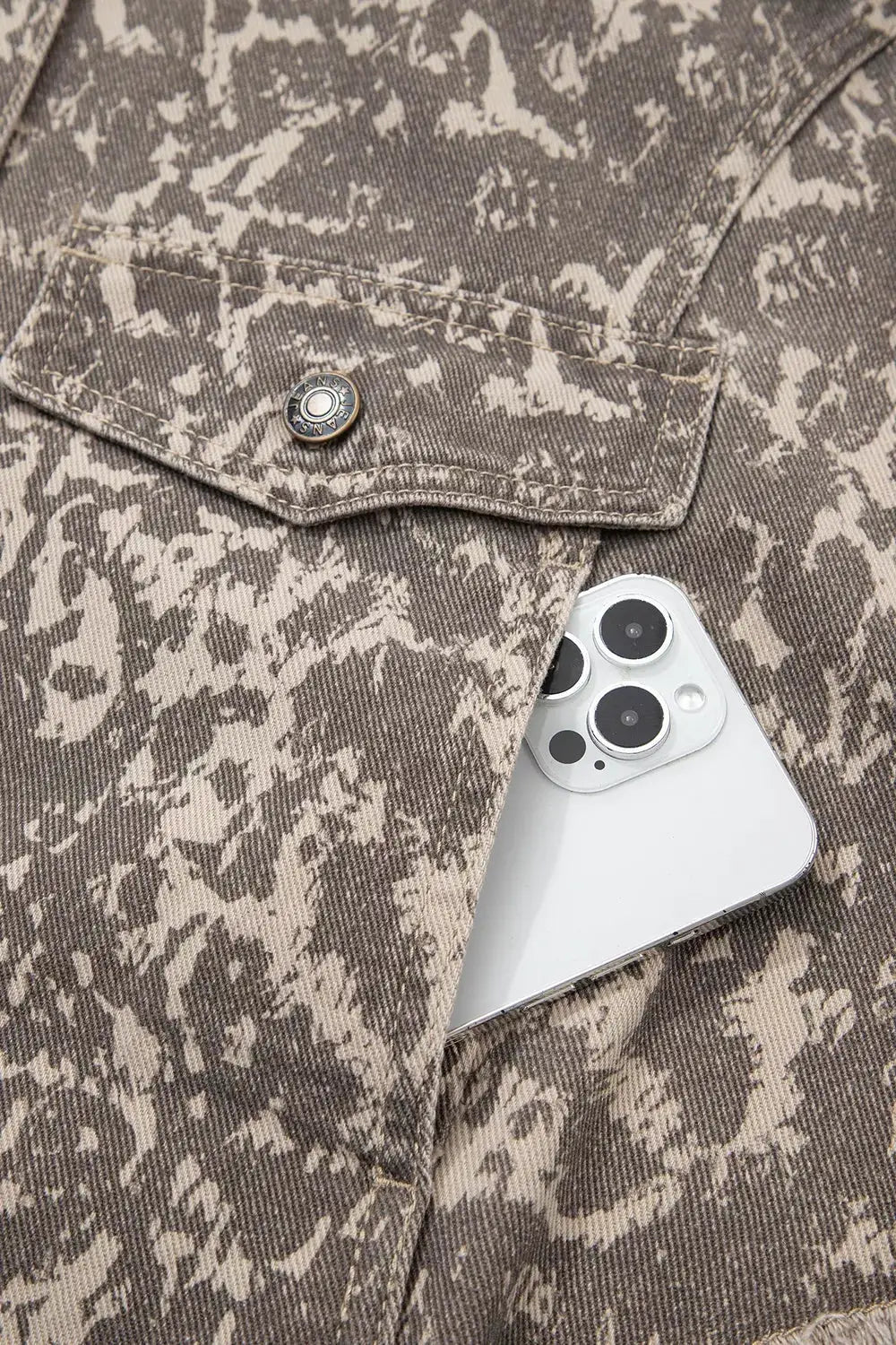 Abstract print denim jacket by Trendsi; beige-brown camouflage pattern, long sleeves, raw hem, phone in pocket