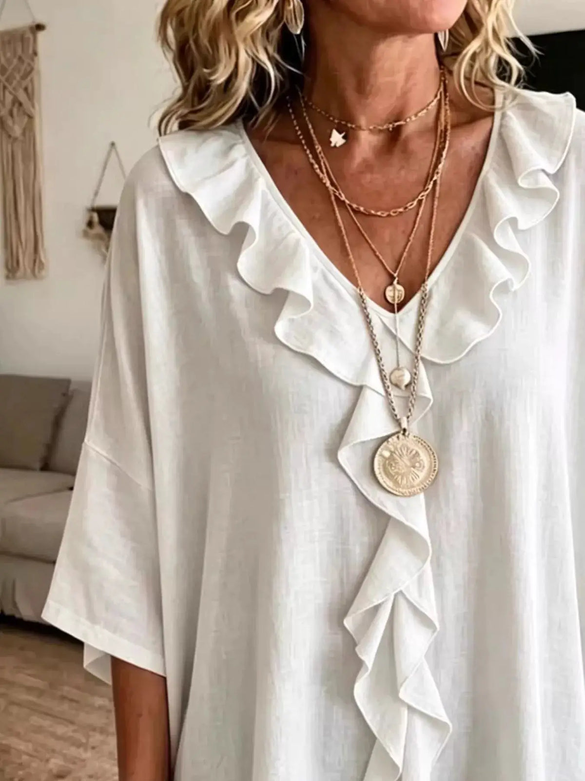 Plus-size white ruffle V-neck blouse with 3/4 sleeves, flowy fabric