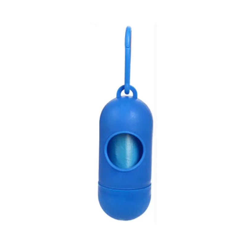 Pet waste bag dispenser for dogs in blue plastic with attached leash clip.