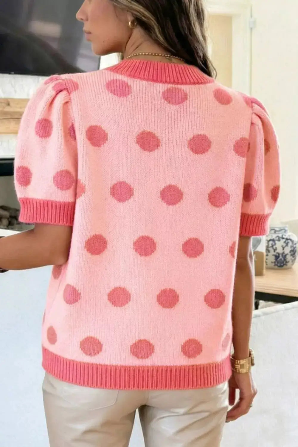 Chic pink polka dot puff-sleeve knit sweater top with gentle stretch; ribbed cuffs and hem.