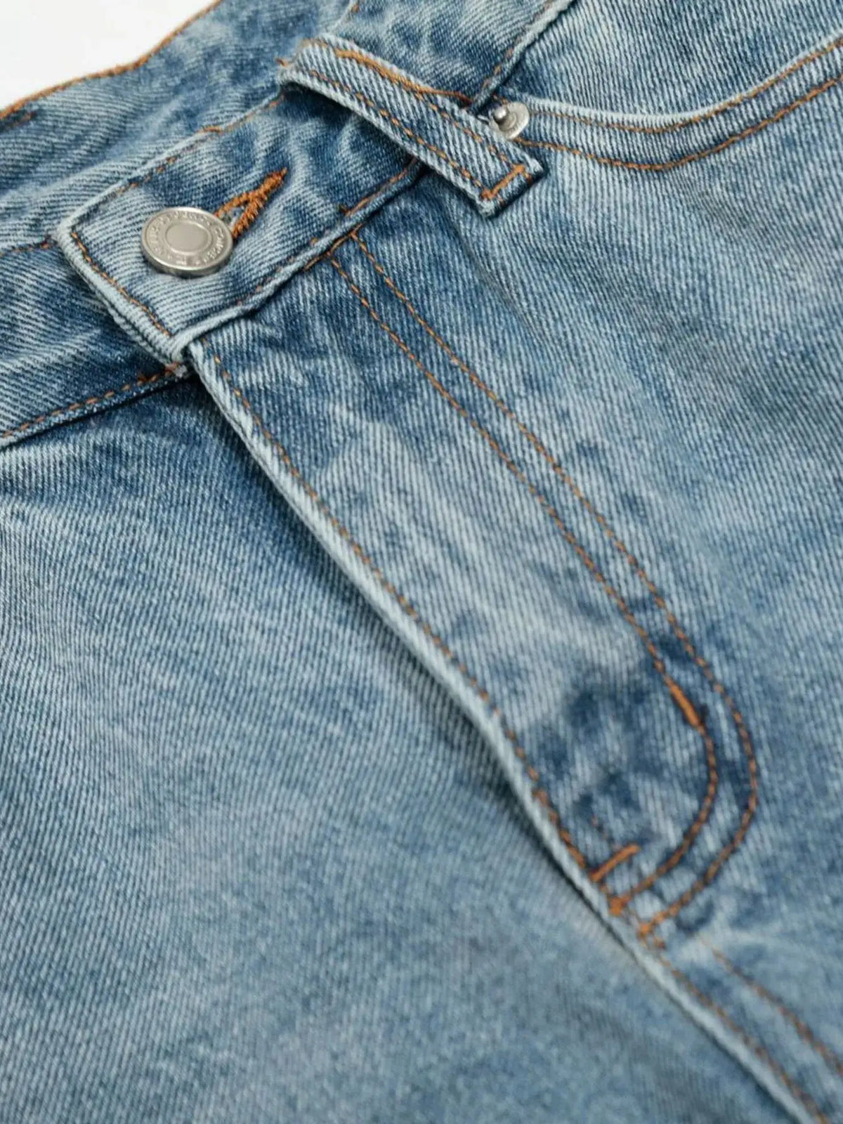 Mens oversized distressed denim shorts blue cotton blend close-up of pocket and metal button