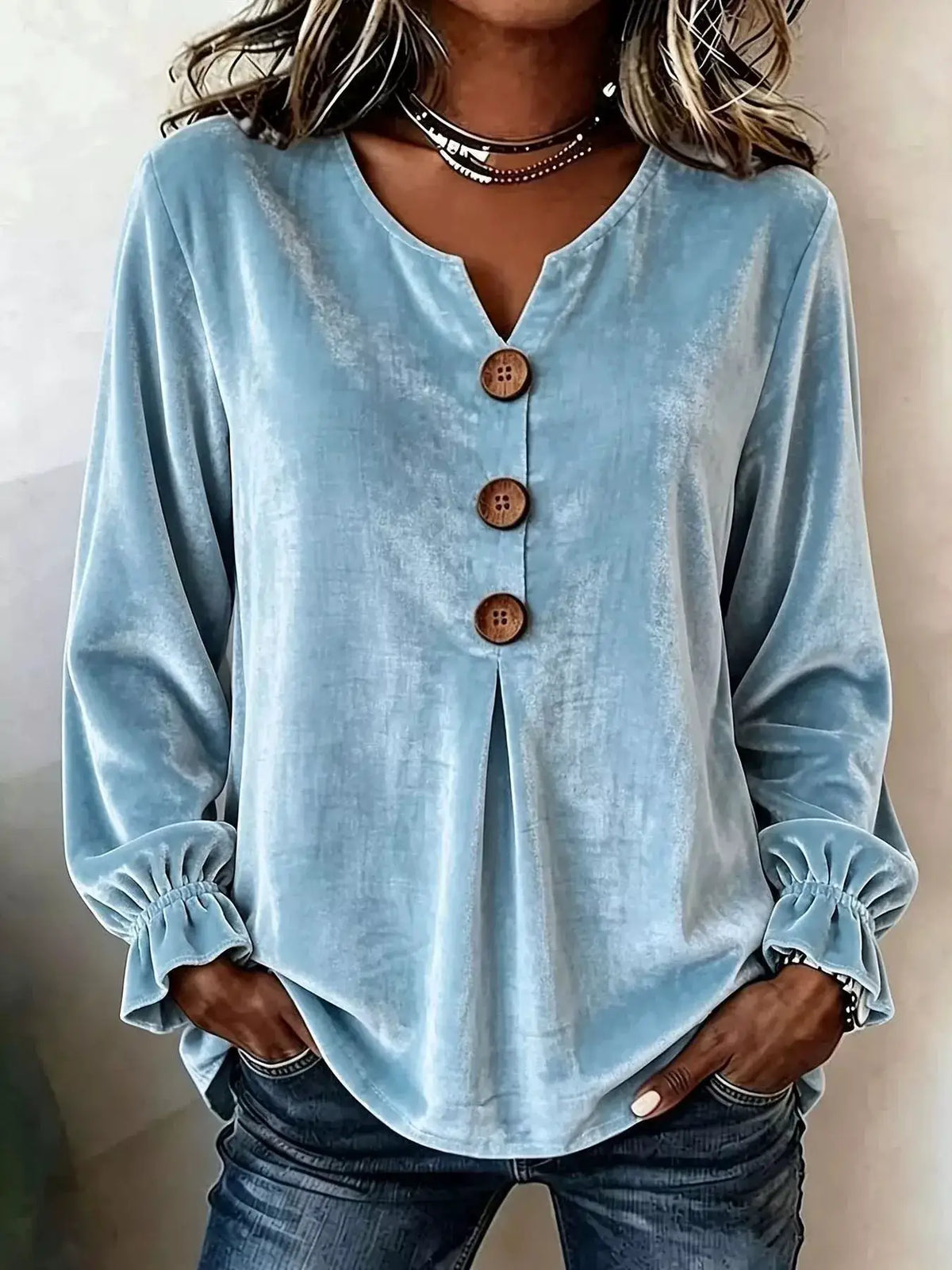 Plus-size velvet button-front blouse in light blue with wooden buttons and ruffled cuffs