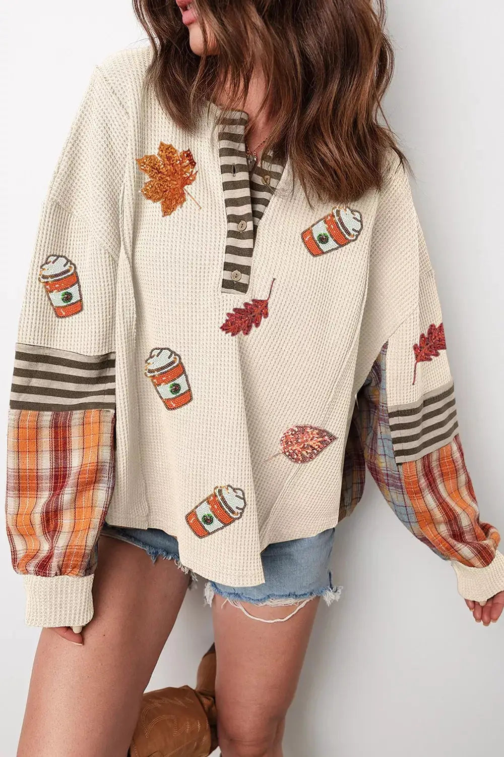 Sequin Autumn Leaf & Coffee Cup Waffle Knit Top by Trendsi, cream waffle-knit with orange plaid sleeves.