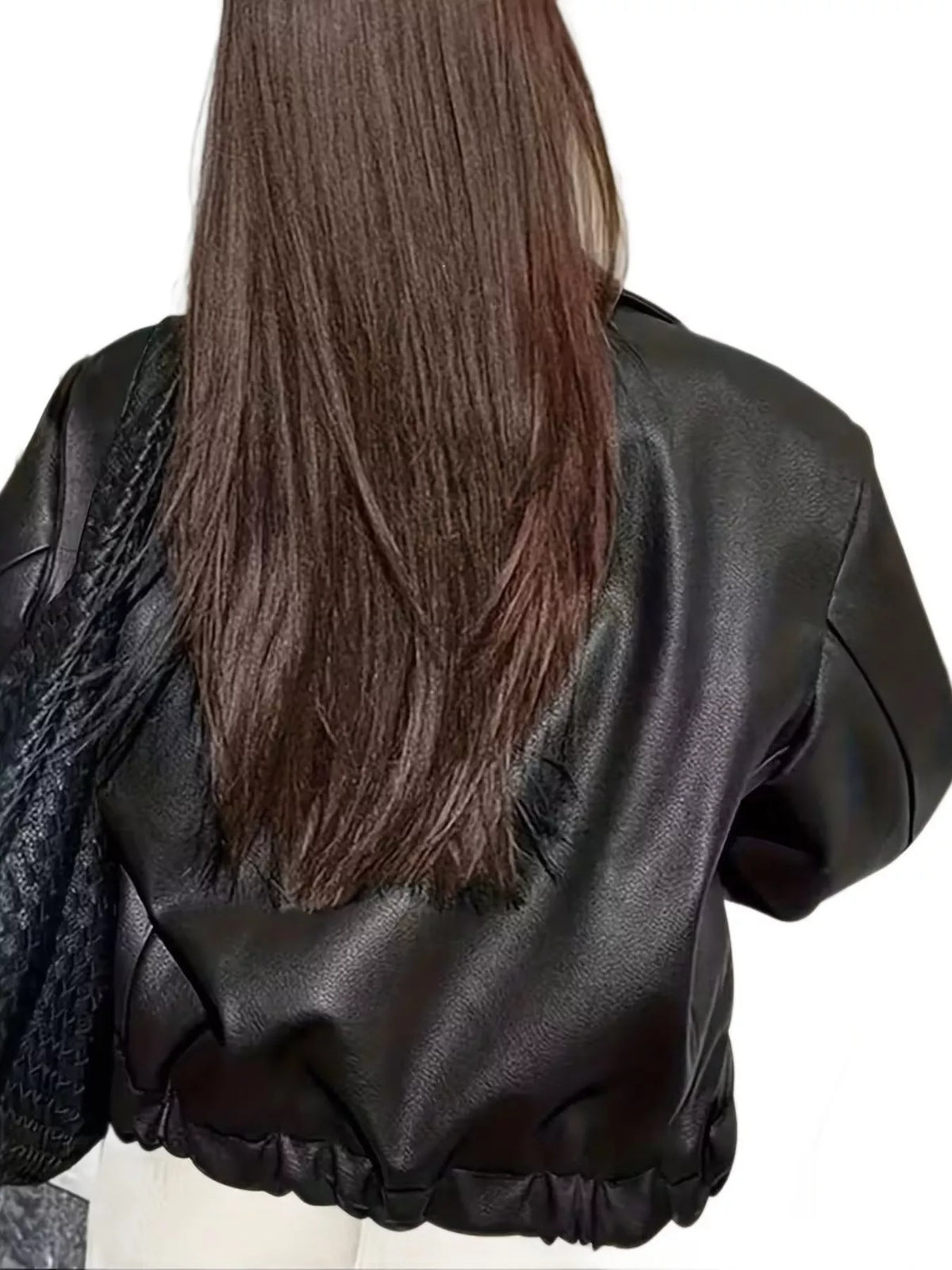 Oversized faux leather moto jacket, black, back view with long brown hair and elastic bottom hem.