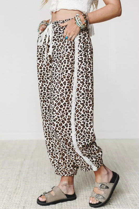 Leopard print ankle-length pants with elastic waist and white lace-trim sides.