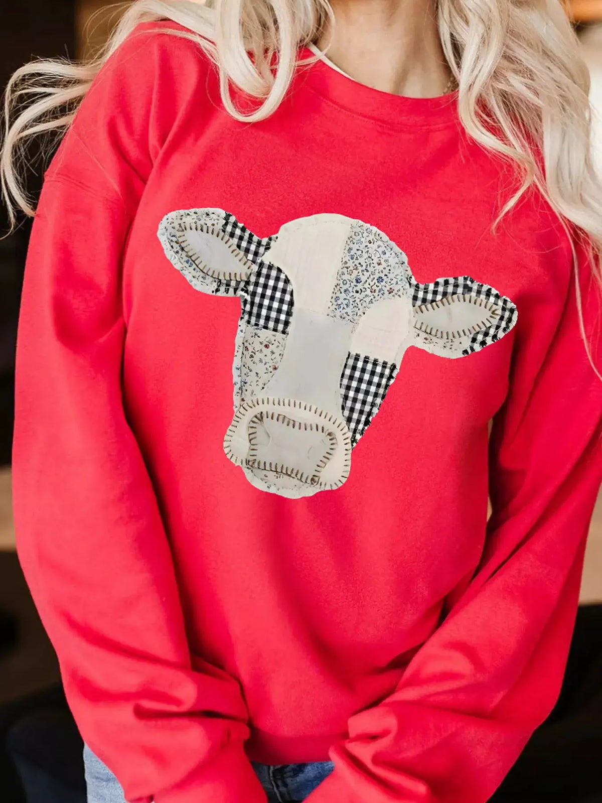 Western Patchwork Cow Drop Shoulder Sweatshirt in red with patchwork cow applique by Trendsi
