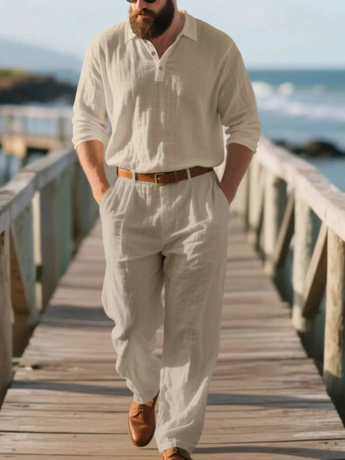 Mens plus-size long-sleeve linen top and pants set by Trendsi in light beige with brown belt on a seaside boardwalk