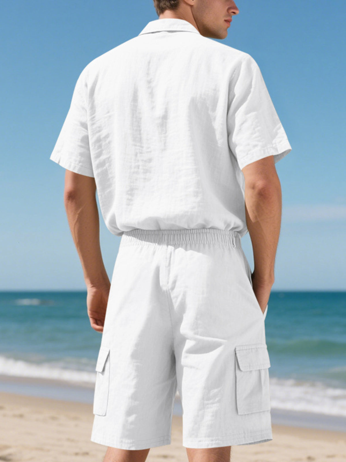 Men's plus-size white button-up shirt and shorts set by Trendsi, beach backdrop