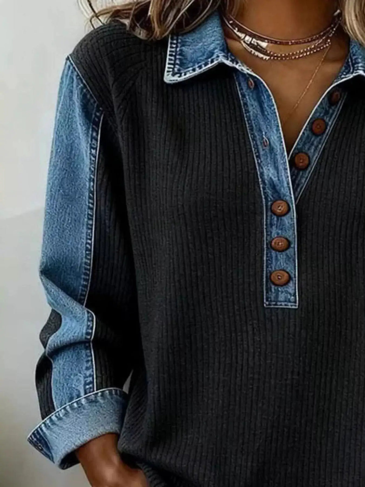 Denim-trim button-detail sweatshirt; black rib-knit with blue denim placket and collar.