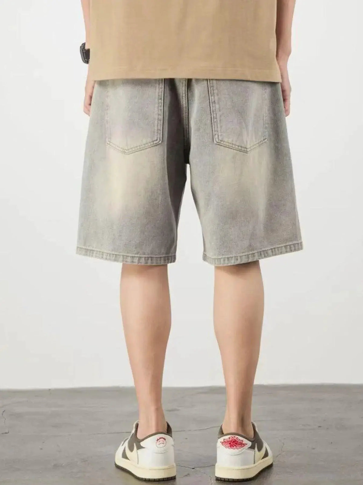 Men's gray denim shorts, relaxed fit, back view with rear pockets