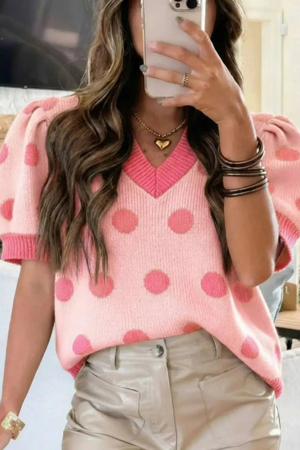 Chic pink knit sweater top with darker pink polka dots, puff sleeves, gentle stretch.