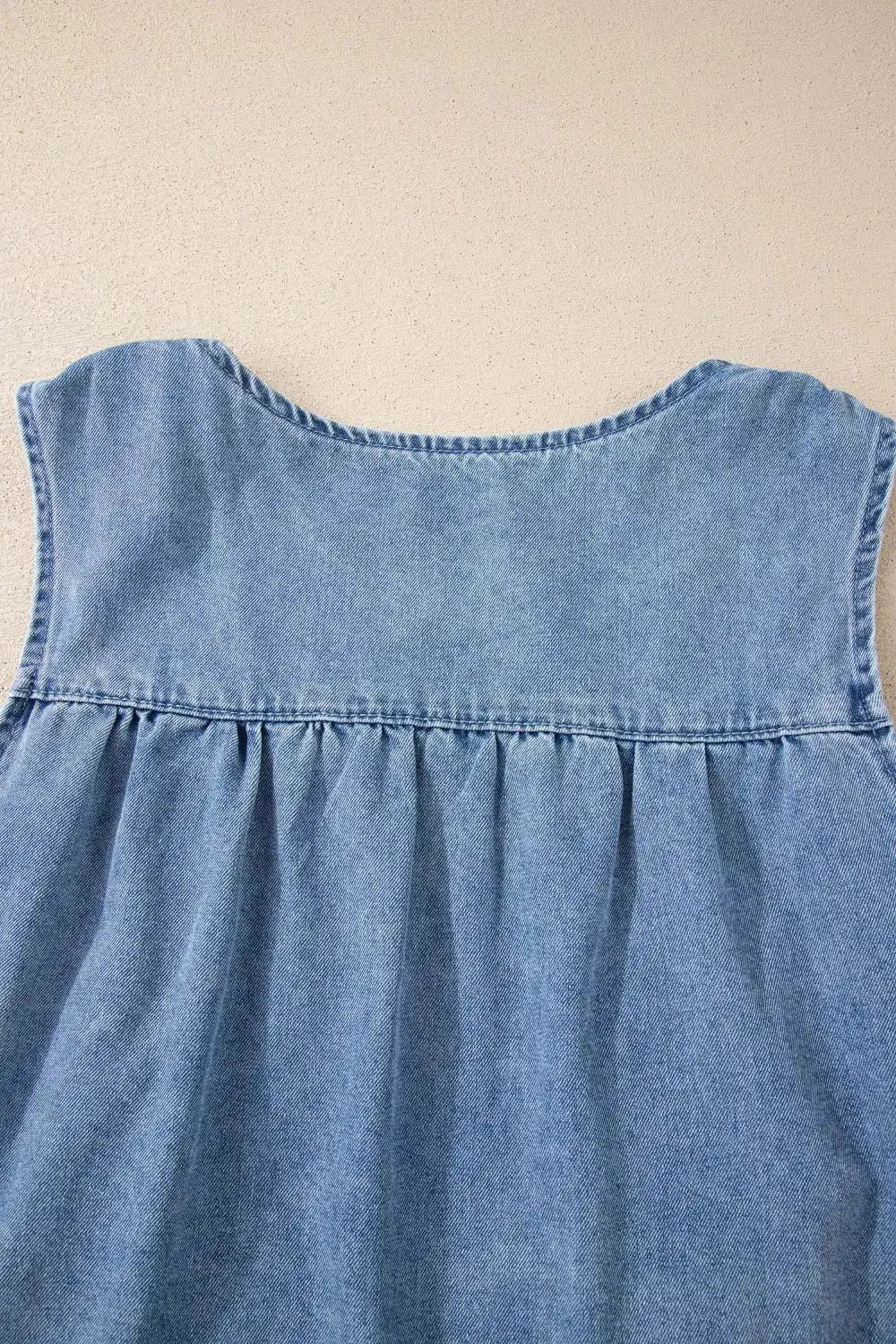 Women denim pleated patchwork sleeveless top in light blue with gathered pleats at the yoke