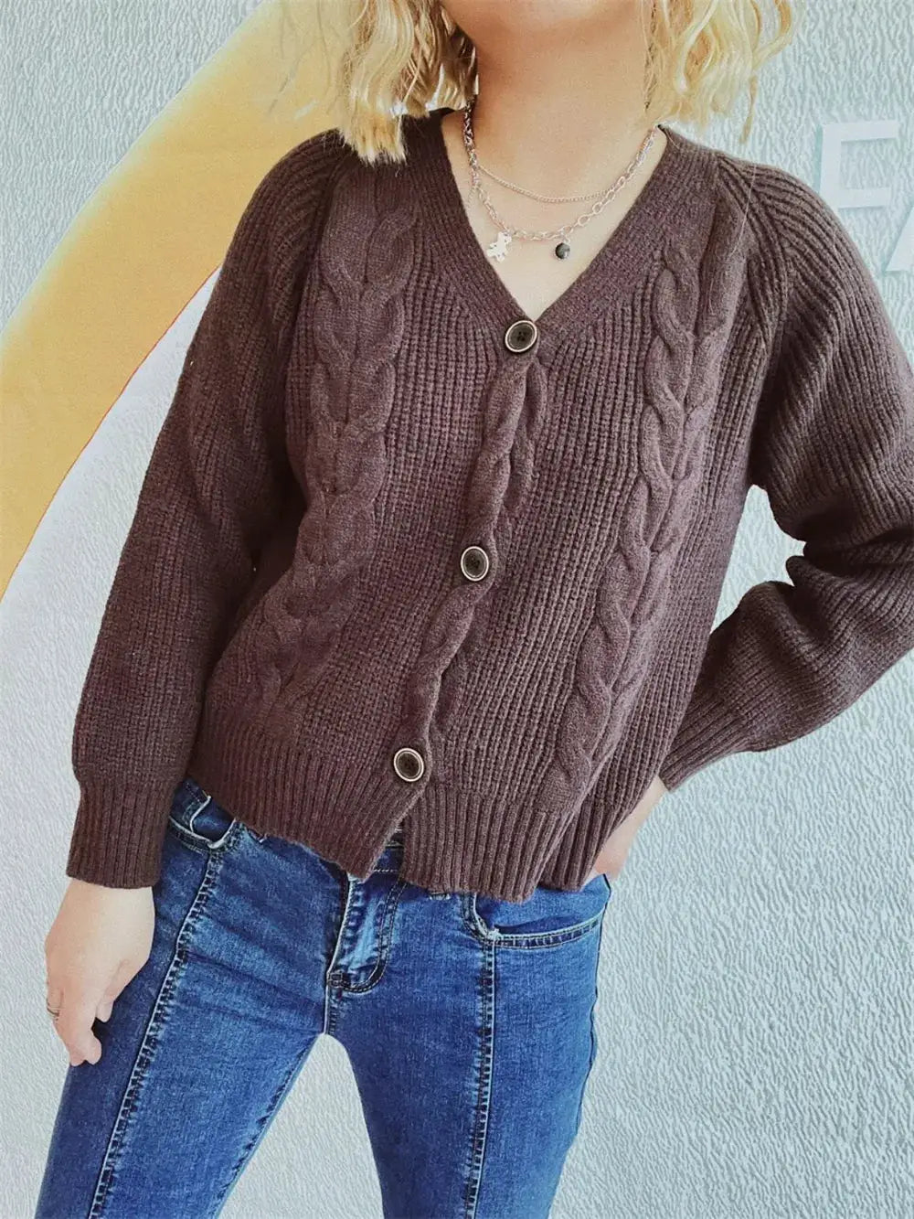Cardigan in soft brown cable-knit V-neck with button-front and long sleeves.