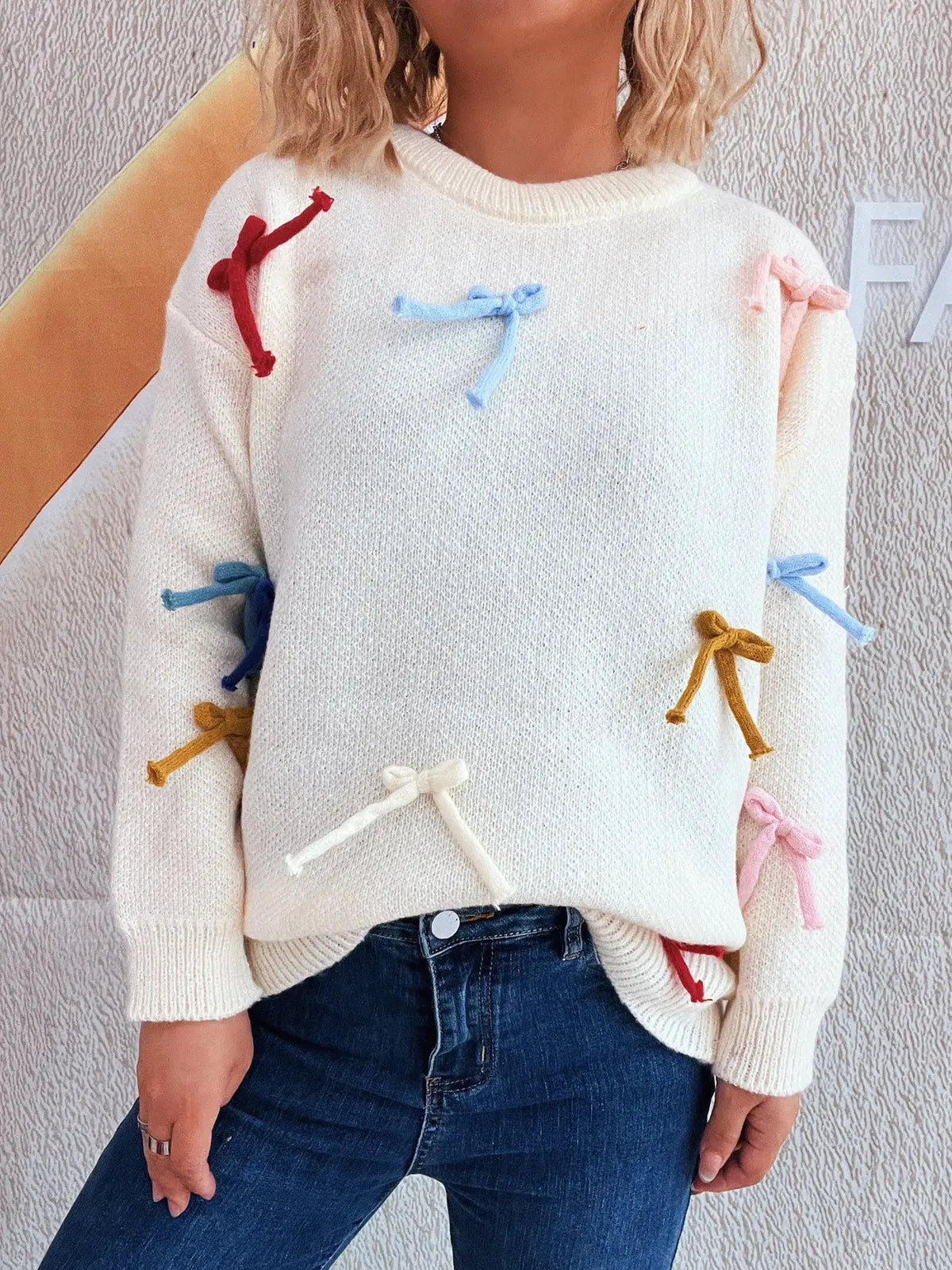 Vibrant bow-accent round-neck white knit sweater for women with multicolor ribbon bows