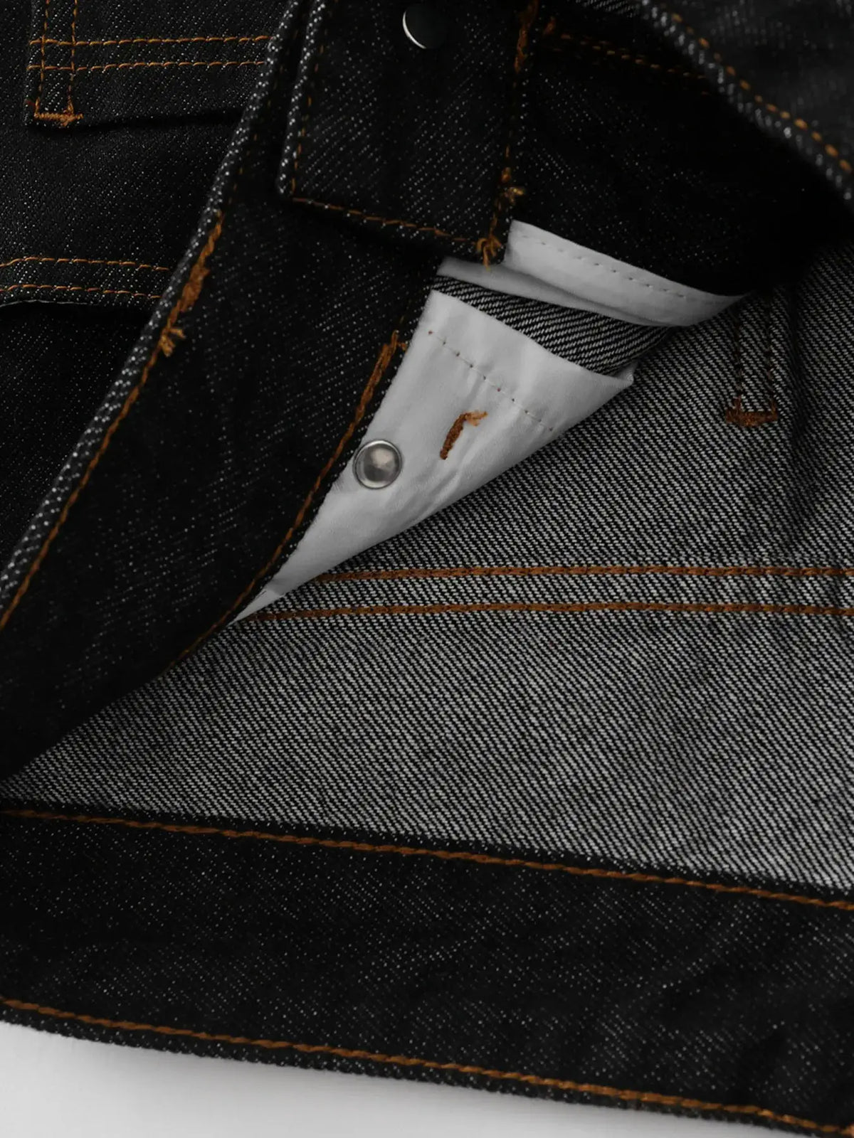 Men's denim shorts in dark indigo with orange contrast stitching and metal pocket rivet