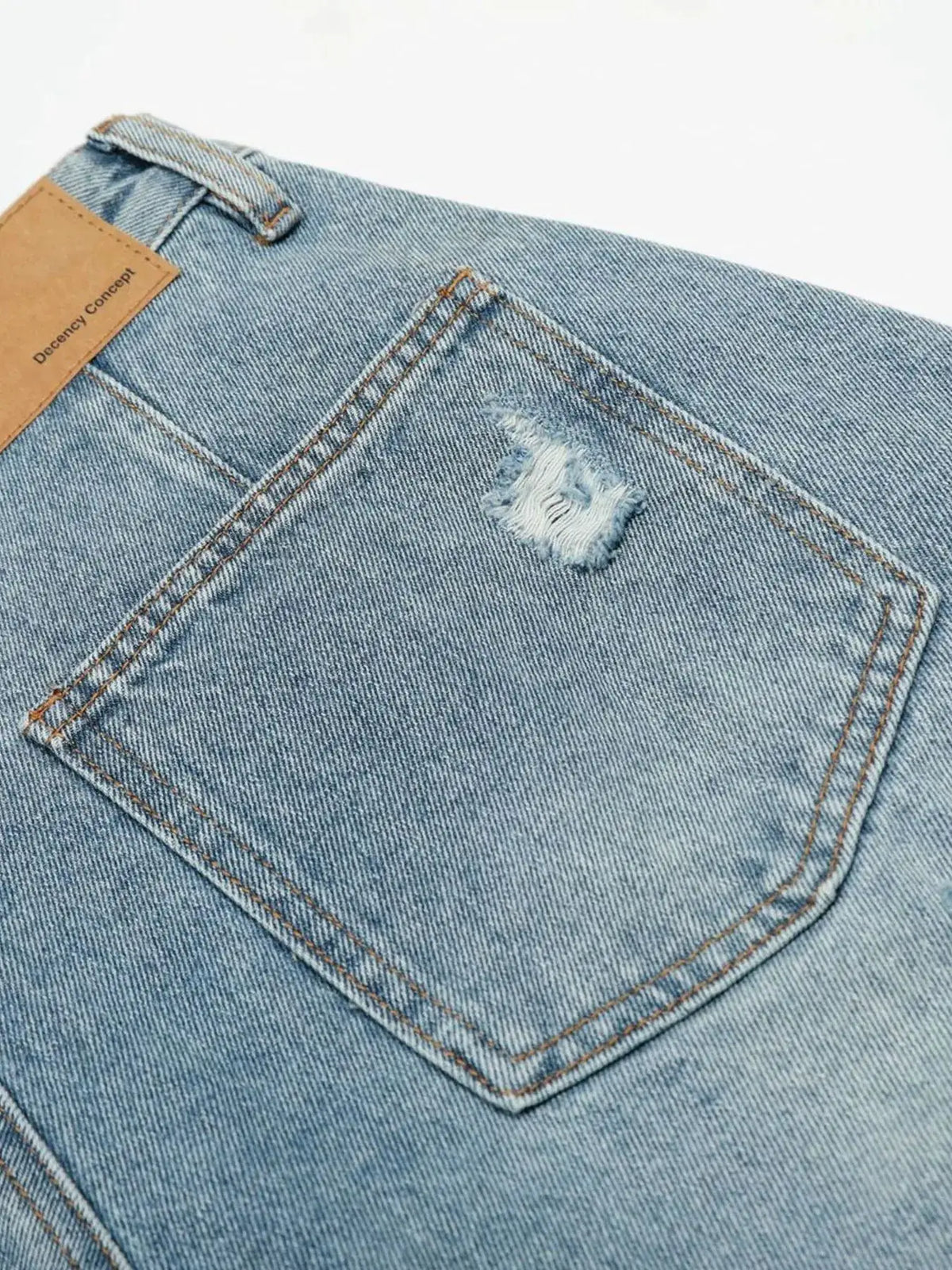 Mens oversized distressed denim shorts in light blue wash with belt loop and small ripped detail