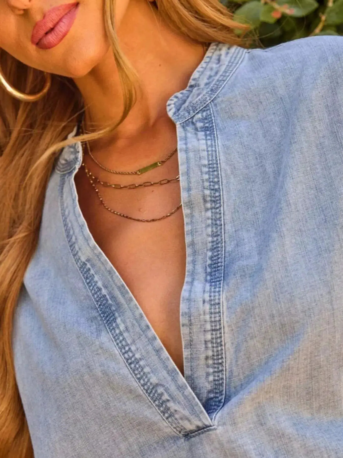 Relaxed washed denim top with notched neckline and drop shoulder in light blue