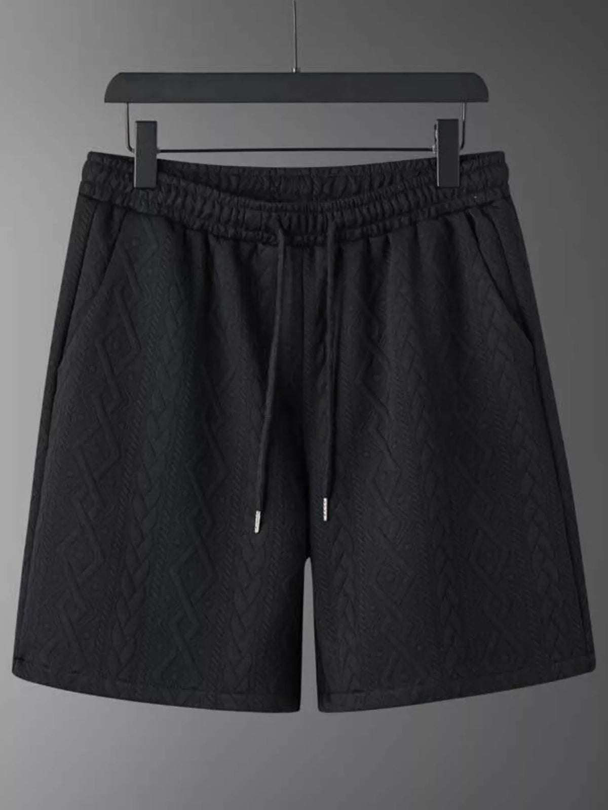 Men's black textured knit shorts with elastic waist and drawstring