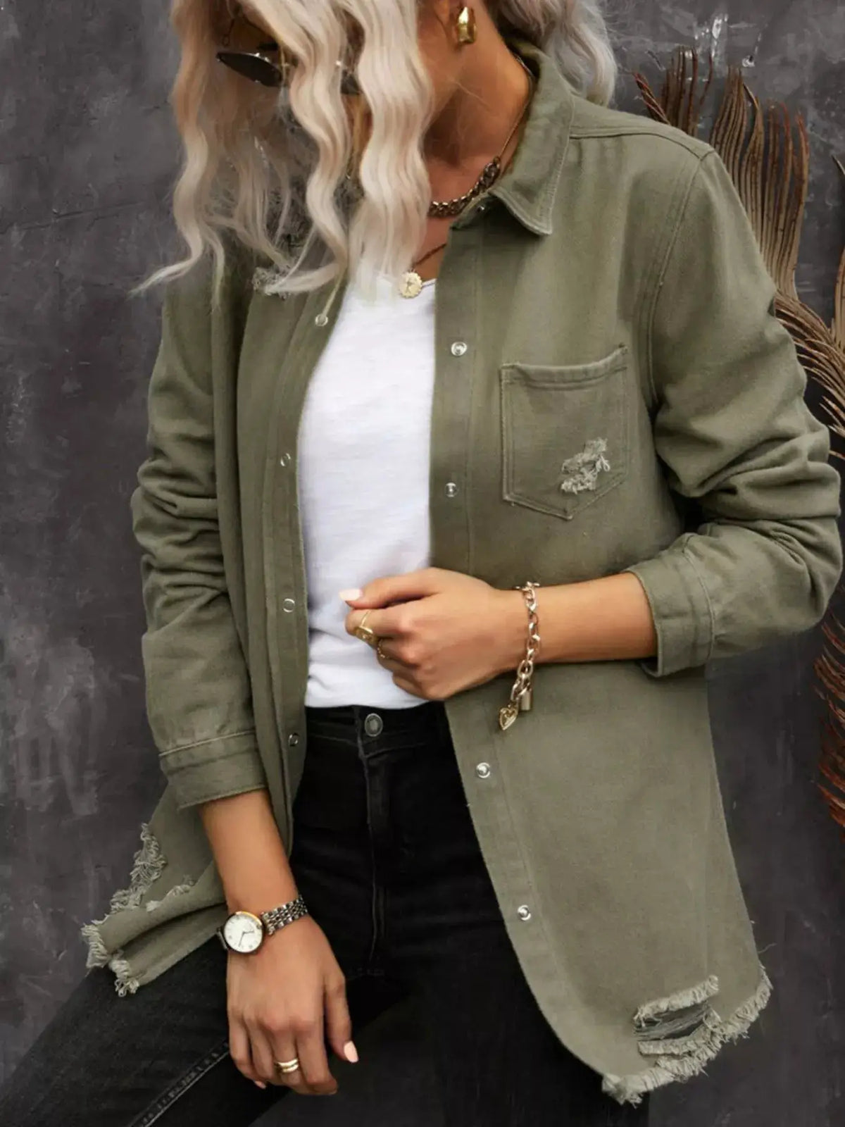 Premium heavyweight olive-green denim shirt jacket with distressed raw hems, worn over a white tee