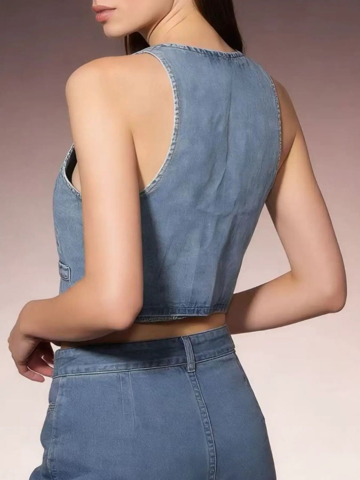 Classic denim vest back view in light wash; sleeveless cotton-blend layering jacket