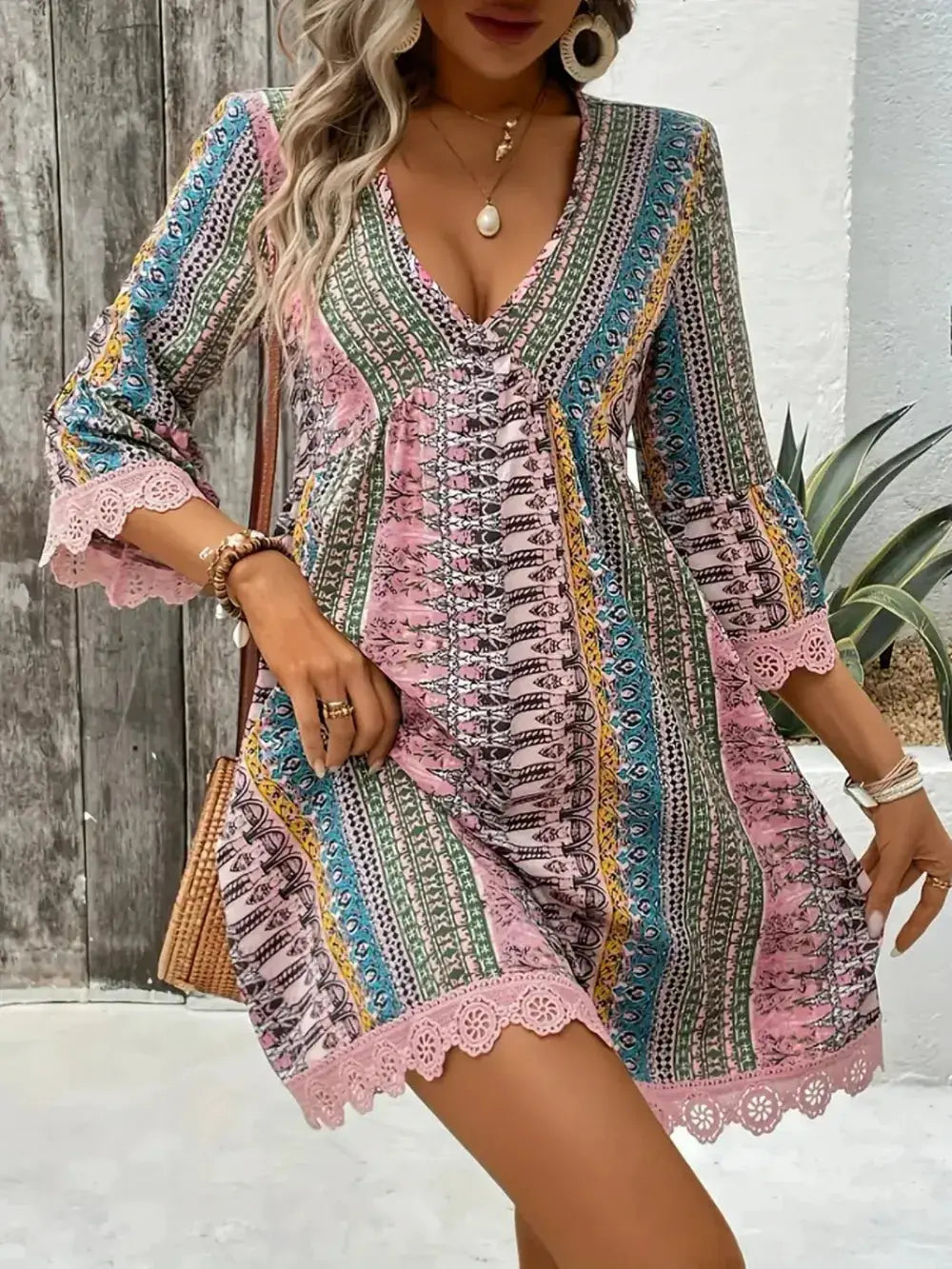 Lace-trimmed printed V-neck dress with 3/4 sleeves in a multicolor striped pattern.