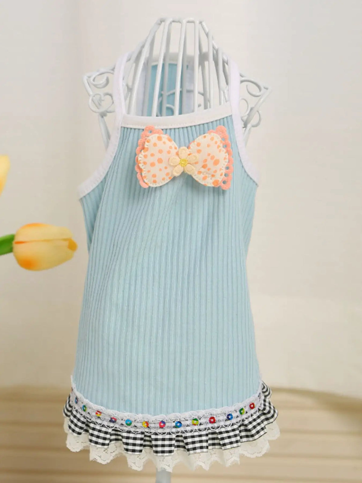 Bowknot Ruffled Hem Pet Top by Trendsi in light blue ribbed fabric with white trim and a peach polka-dot bow