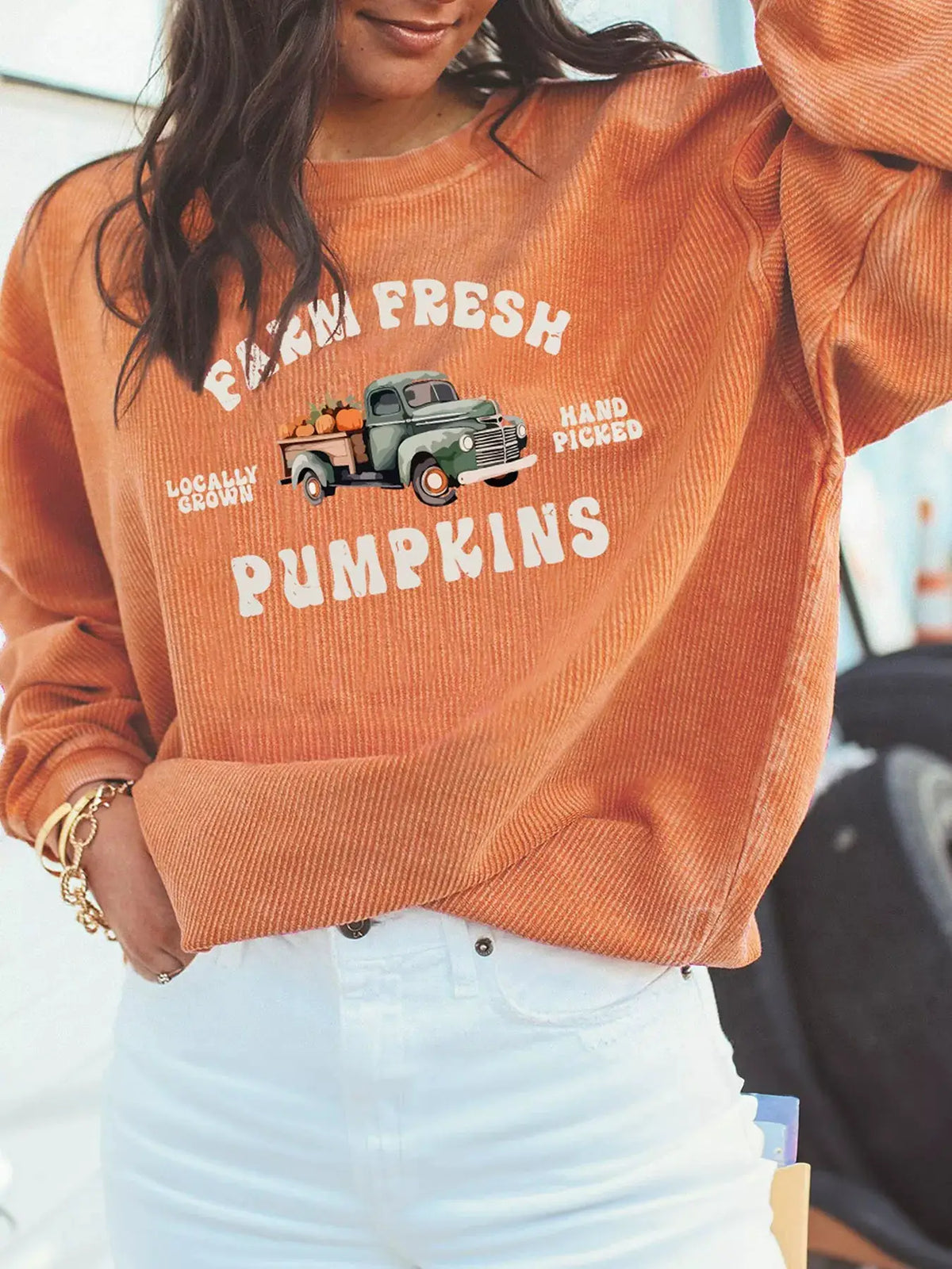 Corded ribbed orange sweatshirt featuring farm-fresh pumpkins graphic with a green vintage truck