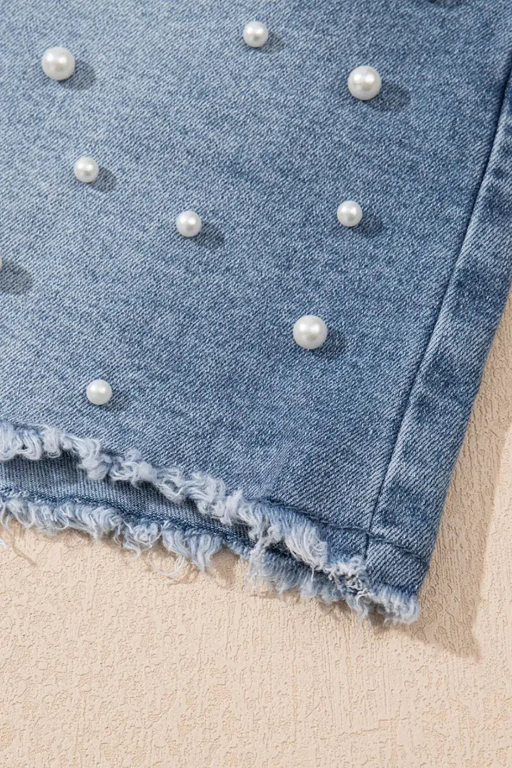Classic Pearl Beaded Raw Hem Washed Cotton Blend Denim Shorts by Trendsi; blue denim with pearl beads.