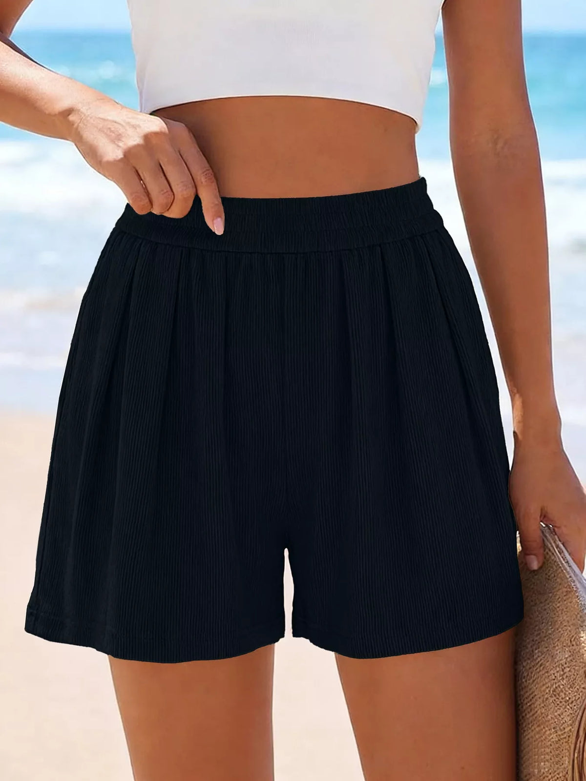 High-Waisted Shorts in black ribbed fabric for a sleek beach-ready look