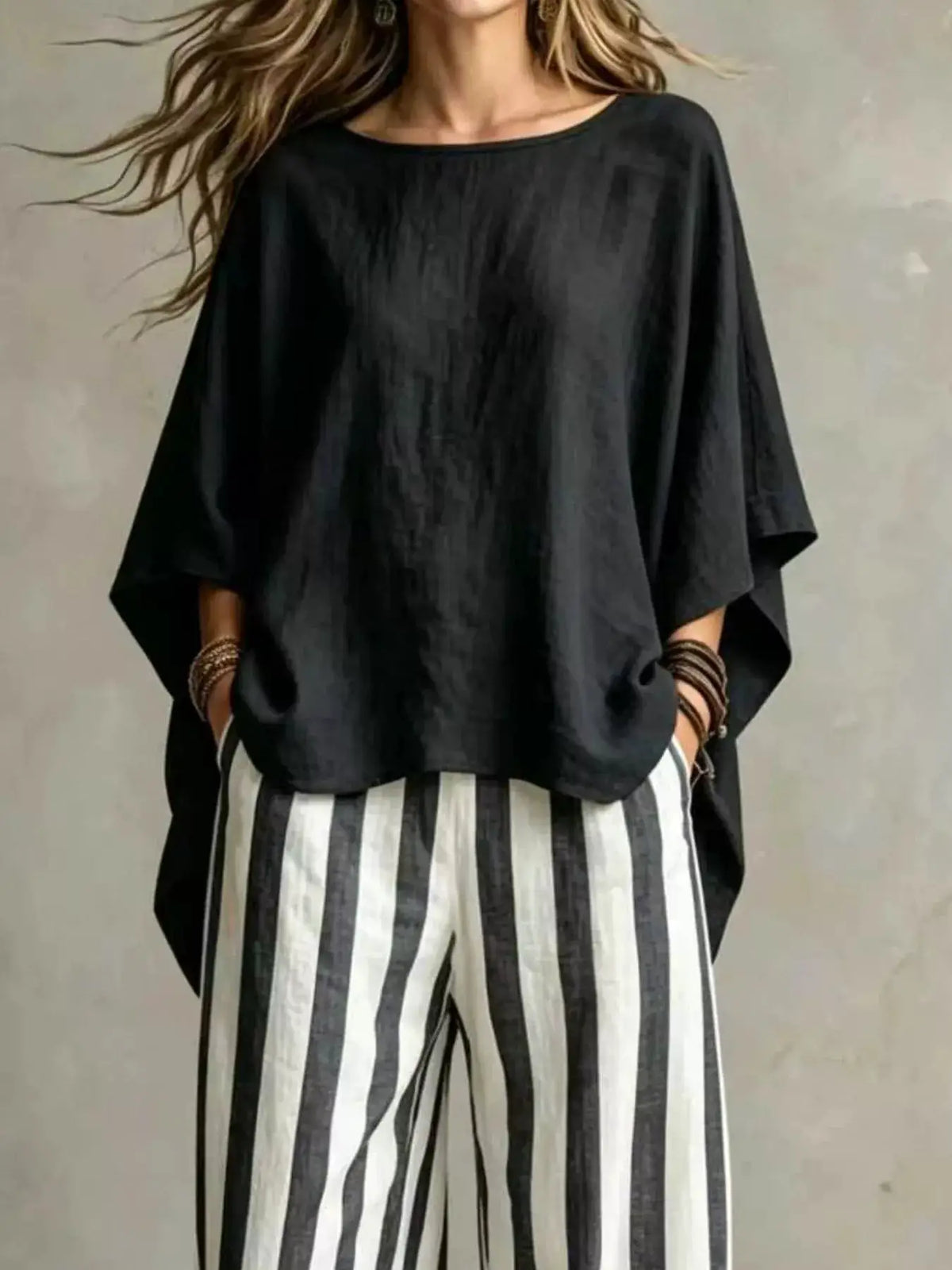 Trendsi plus-size top and striped pants set; black oversized top with vertical black-and-white striped pants