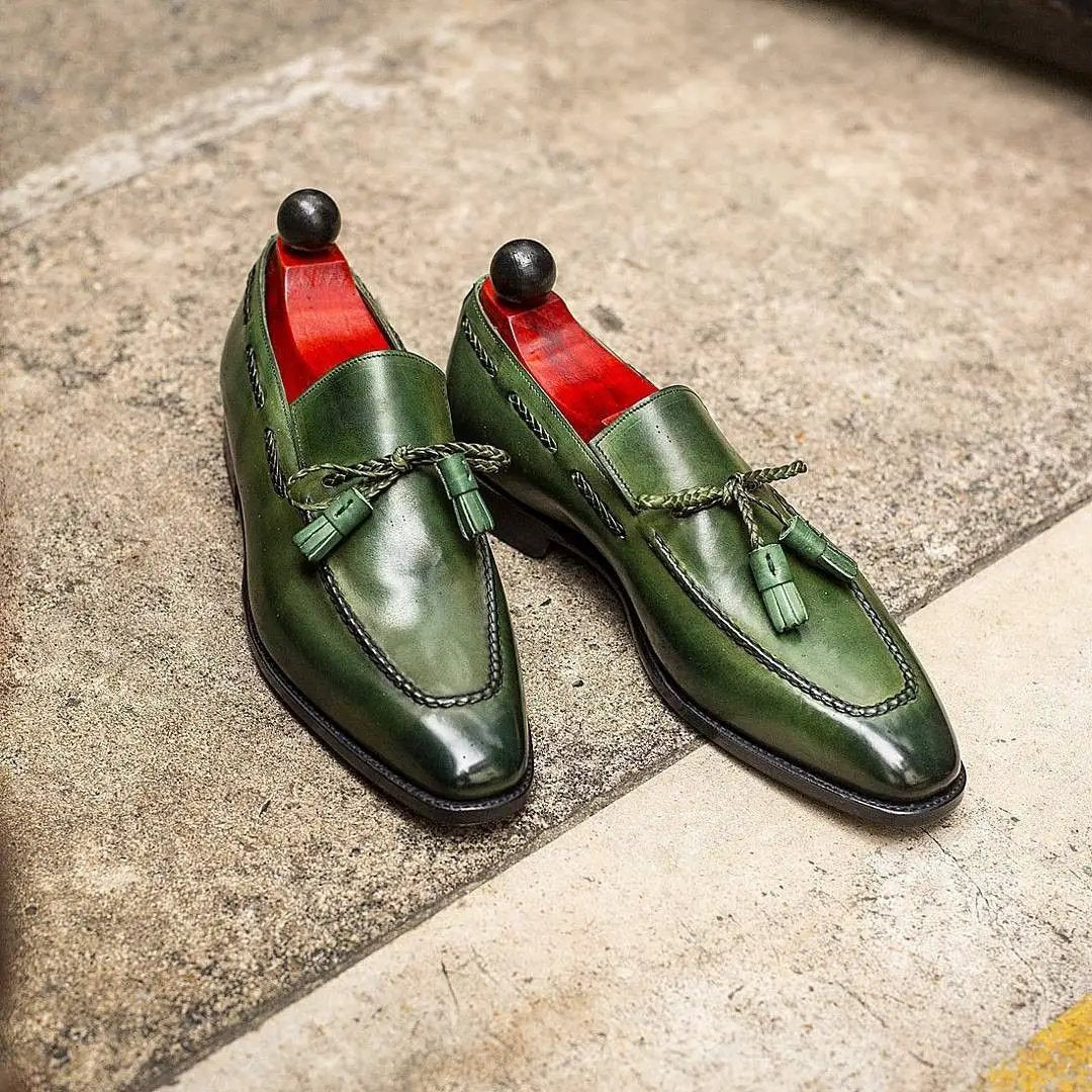 Kensington green PU slip-on tassel loafers pair; glossy finish with braided tassels and red interior lining