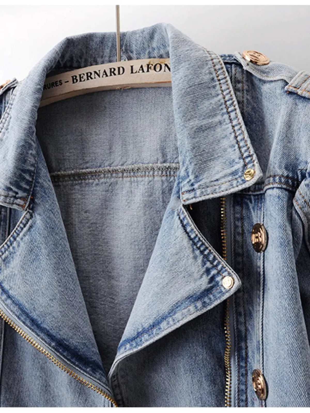 Asymmetrical zip front belted denim jacket in light blue denim with Bernard Lafon label