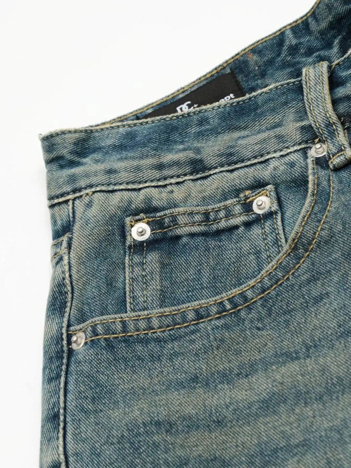 Men's Distressed Camo Patchwork Denim Shorts, blue denim, relaxed fit; close-up of front pocket with metal rivets.