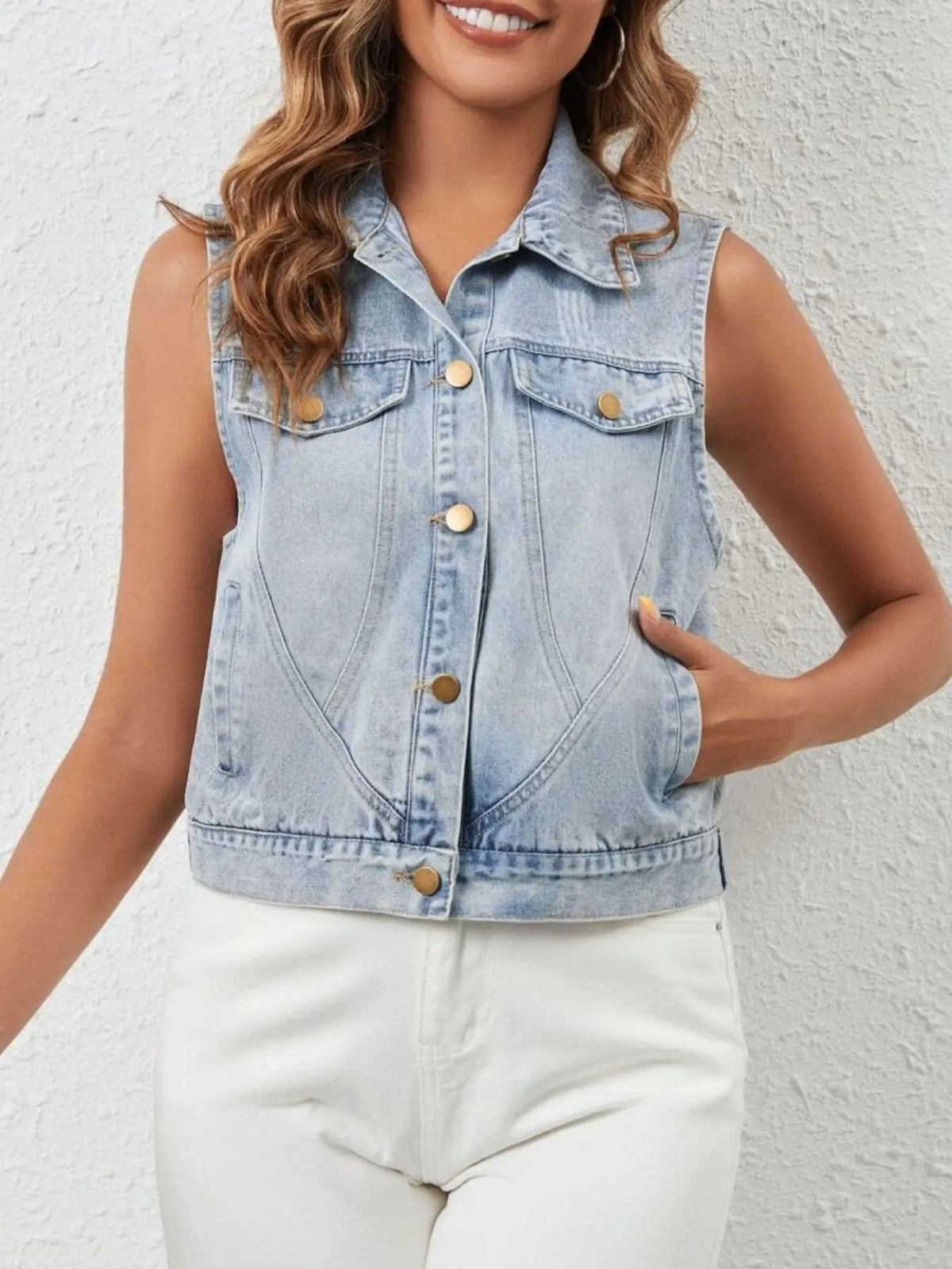 Casual sleeveless denim jacket with button front and pockets, light wash blue