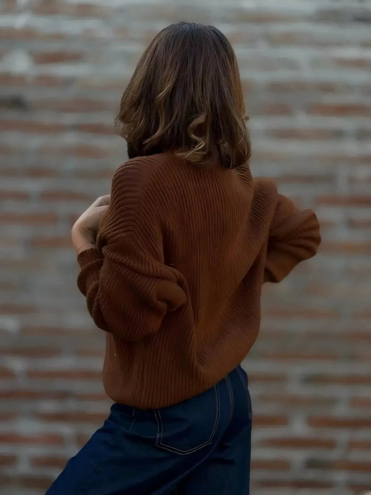 Plus size V-neck button-up knit cardigan in rust brown with a ribbed texture.