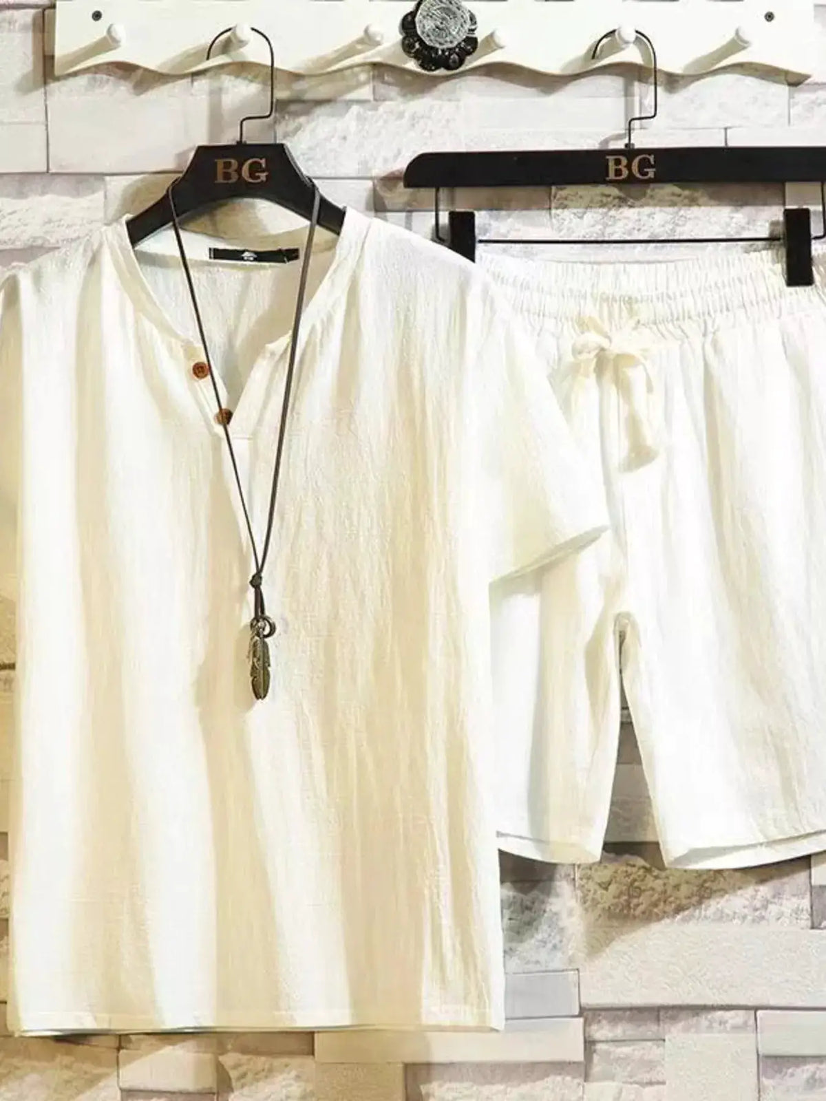 Men’s plus-size cotton short-sleeve top and matching drawstring shorts set in cream on hangers