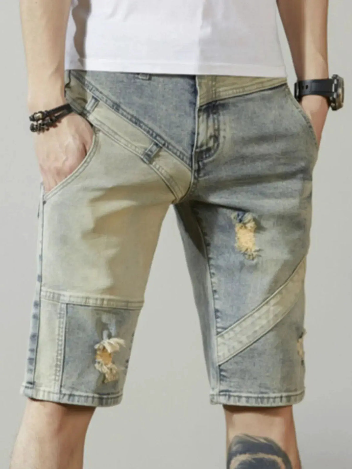 Men's relaxed-fit stretch denim shorts with distressed wash and light-blue patchwork.