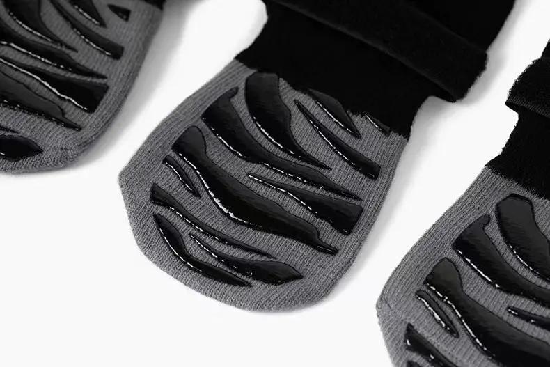 Pet sock shoes for dogs and cats, gray fabric with black non-slip soles; 3 shown