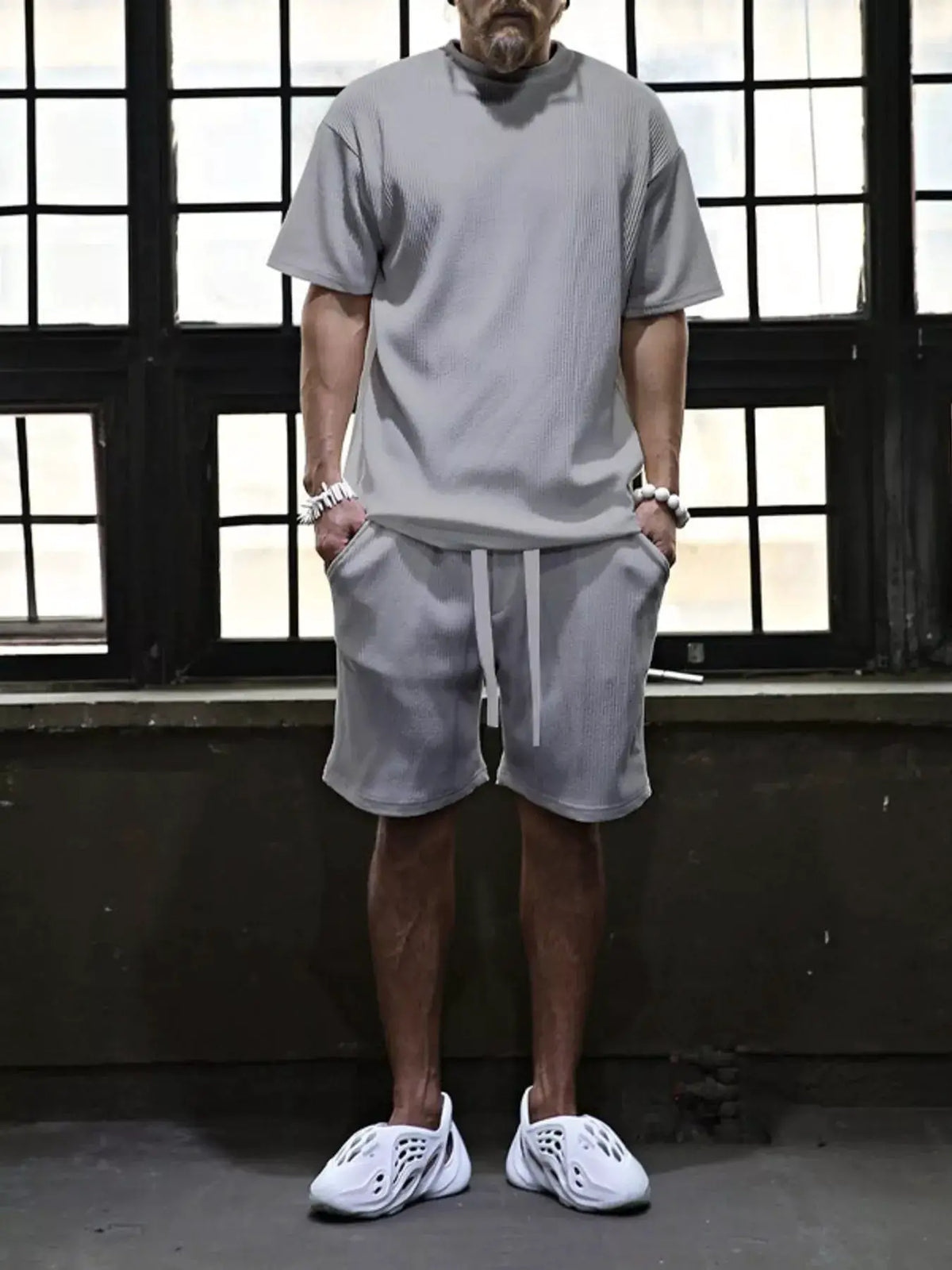 Men's two-piece gray short-sleeve top and shorts set with drawstring pockets
