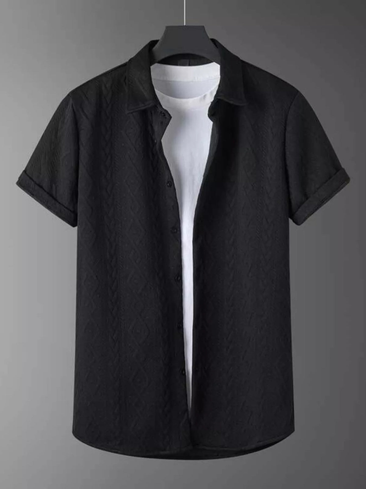 Men's textured knit black polo set with short sleeves, displayed on hanger over a white tee