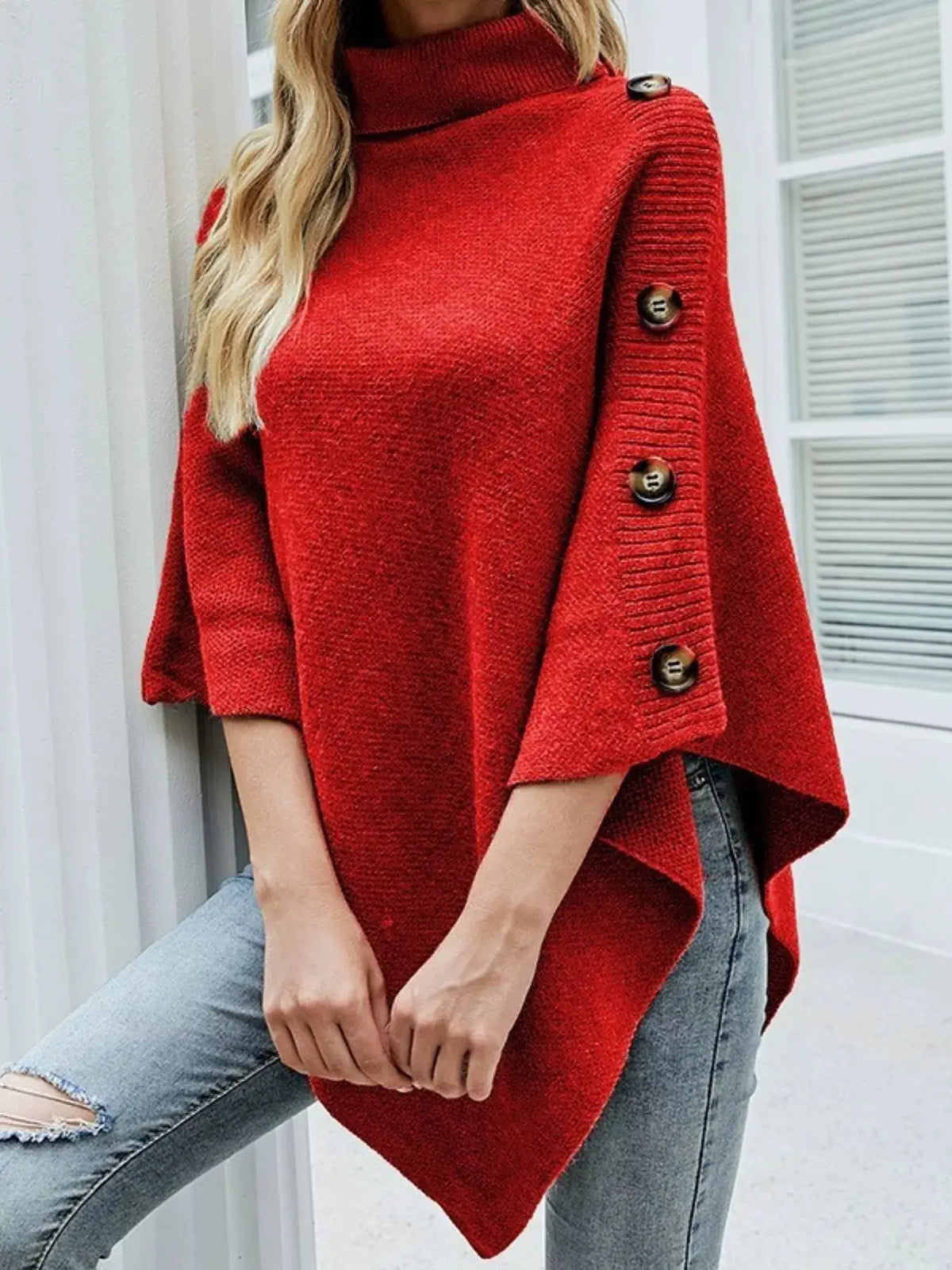 Red knit button-turtleneck poncho pullover with oversized fit and three-button sleeve detail