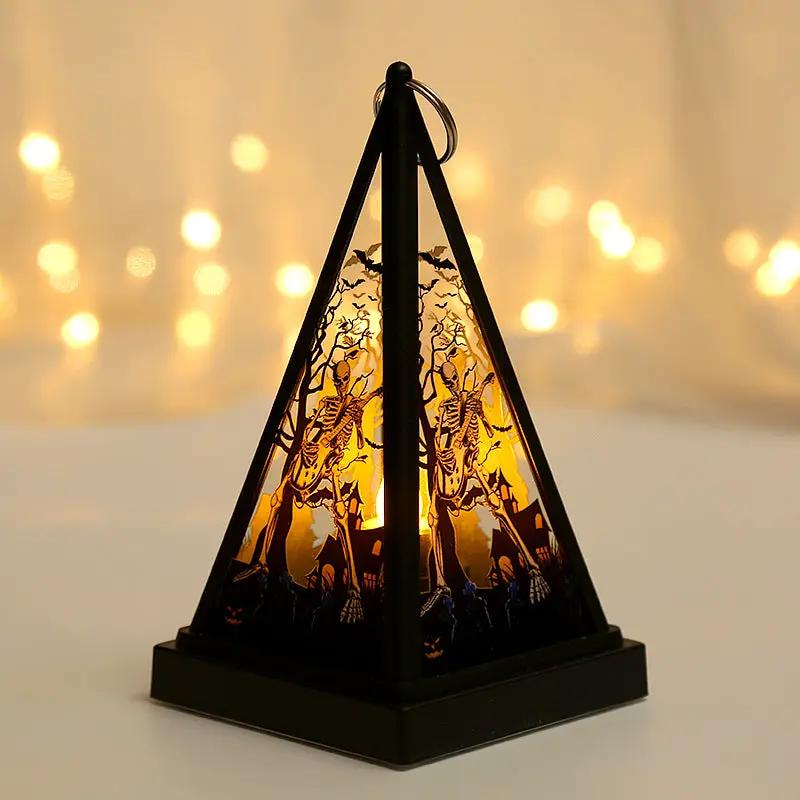 Halloween skeleton lantern with triangular black frame and orange glow, a spooky desktop decoration.