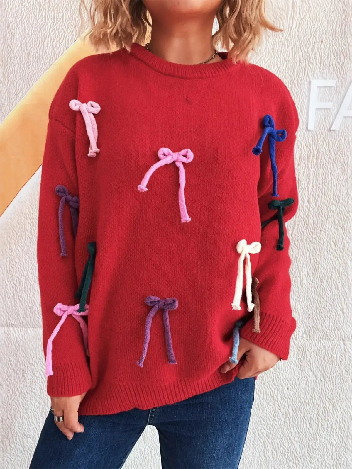 Red bow-accent round-neck pullover sweater for women with multicolor bows