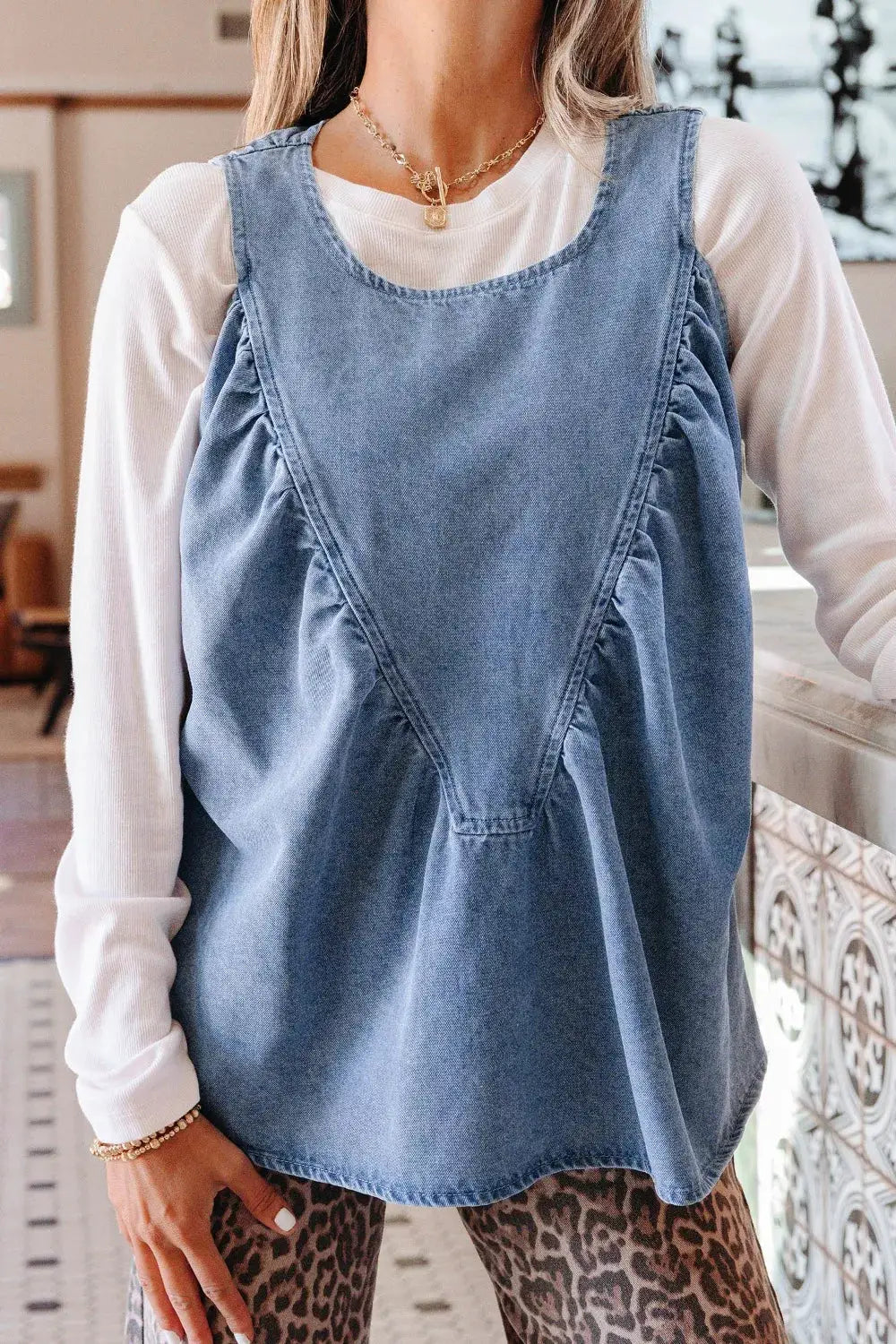 Women denim sleeveless top with V-pleated yoke and side ruffles in light blue