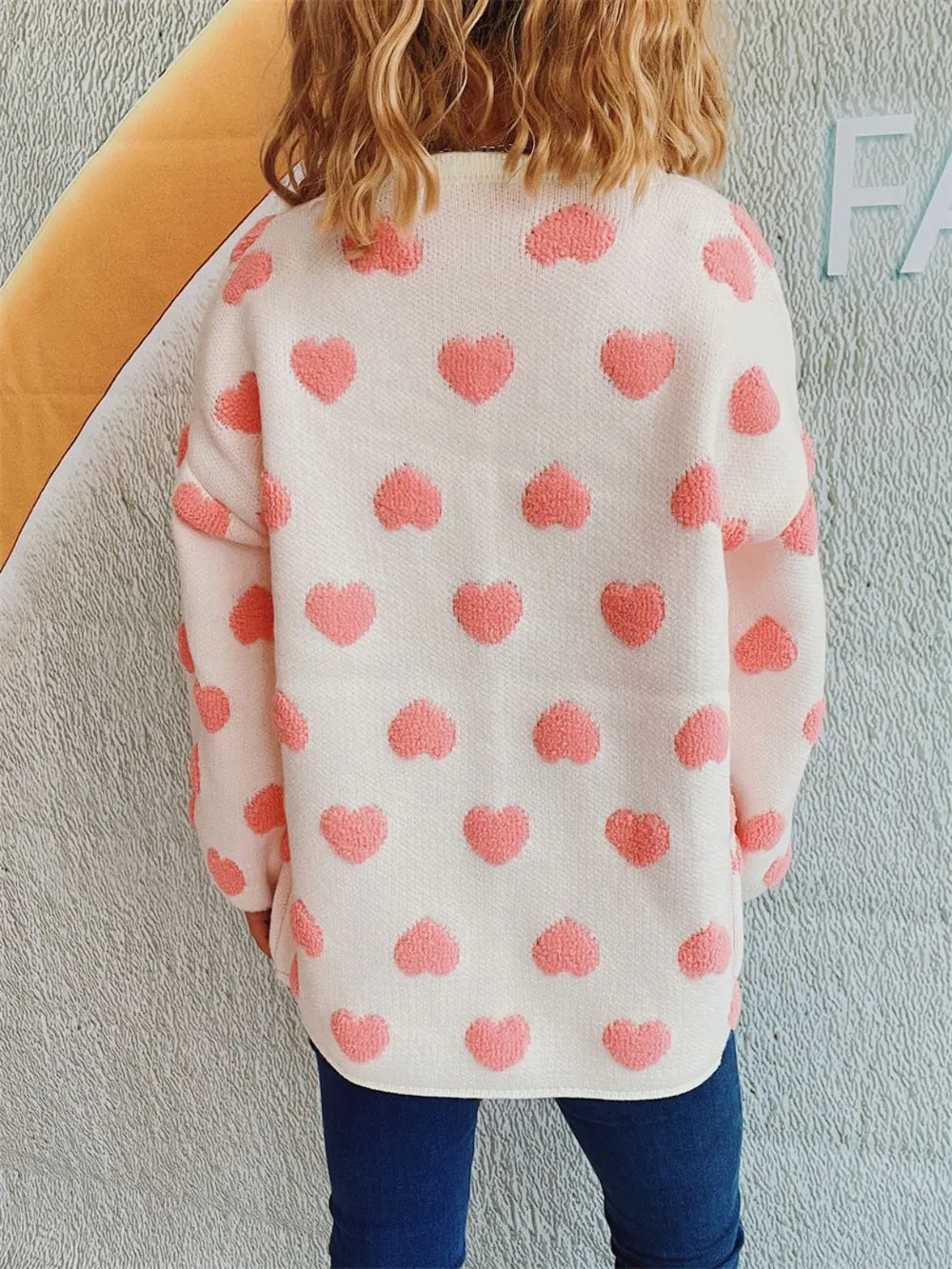 Cozy Heart Button Front Long Sleeve Knit Cardigan by Trendsi; white with pink hearts.