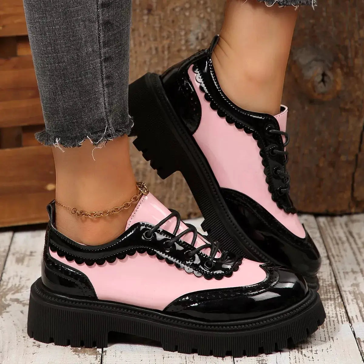 Round toe lace-up sneakers in pink and black with scalloped trim and a chunky platform sole